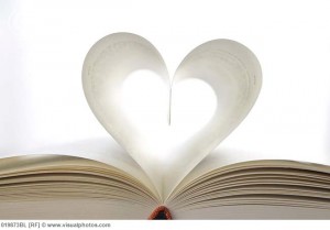 still life of book with pages forming heart